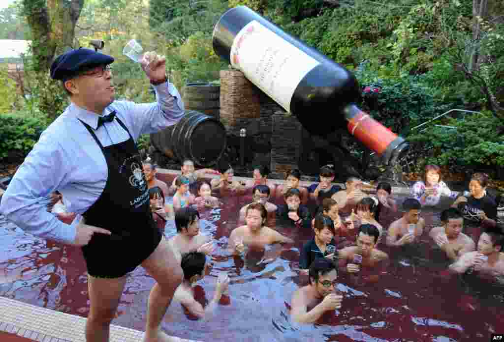 Bourgogne wine maker Laboure-Roi vice president Thibault Garin (L) toasts the company&#39;s 2013 Beaujolais Nouveau wine with guests in the wine spa at the Hakone Yunessun spa resort facilities in Hakone town, Kanagawa prefecture, some 100-kilometer west of Tokyo, Japan.