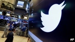 FILE - The Twitter symbol appears above a trading post on the floor of the New York Stock Exchange, July 27, 2016. Twitter, long criticized as a hotbed for online harassment, is expanding ways to curb the amount of abuse users see and making it easier to report such conduct.