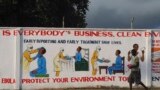 A man walks by a mural with health instructions on treating the Ebola virus, in Monrovia, November 18, 2014. REUTERS/James Giahyue (LIBERIA - Tags: HEALTH SOCIETY) - RTR4ENSR