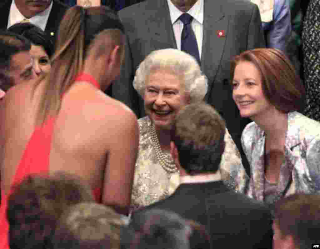 Queen Elizabeth II, second left, laughs with 6 ft 8 in (2.03 m) tall Australian basketball star Liz Cambage, and Prime Minister Julia Gillard, right, at a reception at Parliament House in Canberra, Friday, Oct. 21, 2011. The Queen is on her first visit to