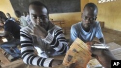 Men wait to retreive their identity cards as well as their electors cards for the presidential elections iin Bouake, Oct 27, 2010