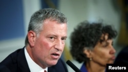 A woman villager cleans garbage in front of her house as flood hits Tanjungsari village in Tasikmalaya, Indonesia.