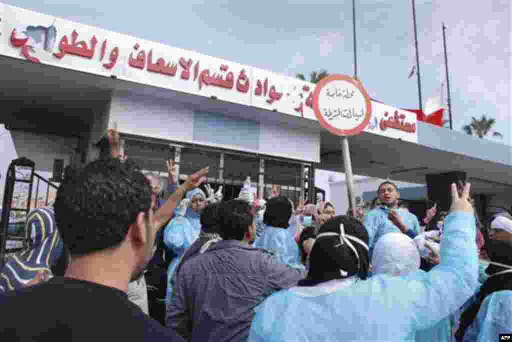 Residents and medical personnel at Al-Jalaa hospital in Benghazi, Libya on Monday, Feb. 21, 2011. Writing in arabic reads "Al-Galaa Hospital, Emergency and Paramedic section". Libyan protesters celebrated in the streets of Benghazi on Monday, claiming con