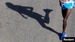 FILE - The shadow of runner is seen in the Nairobi Marathon.