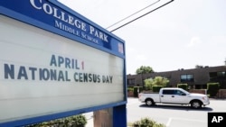 In this March 24, 2020 photo, a sign at a middle school in Orlando, Fla., reminds residents that April First is census day. 