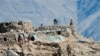 FILE - This photograph provided by the Indian Army, shows Chinese troops dismantling their bunkers in the Pangong Tso region, in Ladakh along the India-China border, Feb. 15, 2021.