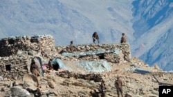 FILE - This photograph provided by the Indian Army, shows Chinese troops dismantling their bunkers in the Pangong Tso region, in Ladakh along the India-China border, Feb. 15, 2021.