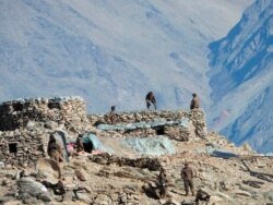 FILE - This photograph provided by the Indian Army, shows Chinese troops dismantling their bunkers in the Pangong Tso region, in Ladakh along the India-China border, Feb.15, 2021.