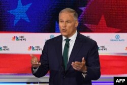 FILE - Jay Inslee speaks during the first Democratic primary debate of the 2020 presidential campaign season at the Adrienne Arsht Center for the Performing Arts in Miami, June 26, 2019.