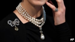 A model wears Marie Antoinettes jewellery at Sotheby's in London, Friday, Oct. 19, 2018. Jewels once owned by the last Queen of France Marie Antoinette will be going up for auction this autumn. And before the auction, the collection is making stops on an international tour where members of the public can view and even try on the royal pieces.