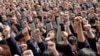 FILE - Students yell slogans such as "I must go to college" and "Father and mother, I love you" following the instructions of a lecturer during a speech at a high school in Nanjing, Jiangsu province, March 28, 2012. The speech aims to boost the morale of students before they sit for their National College Entrance Exams, local media reported. 