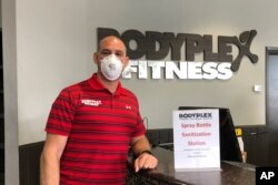 Gym co-owner Mike Martino wears a mask to protect against the coronavirus at Bodyplex Fitness Adventure in Grayson, Ga., on April 24, 2020.