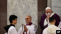 Pope Francis wipes his nose during the Ash Wednesday Mass opening Lent, the forty-day period of abstinence and deprivation for Christians before Holy Week and Easter, inside the Basilica of Santa Sabina in Rome, Italy, Feb. 26, 2020.
