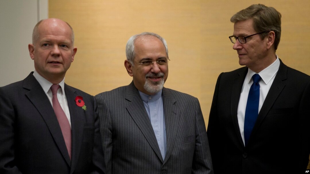 British Foreign Secretary William Hague, left, Iranian Foreign Minister Mohammad Javad Zarif and Germany's Foreign Minister Guido Westerwelle, right, gather for the third day of closed-door nuclear talks at the Intercontinental Hotel in Geneva Switzerland