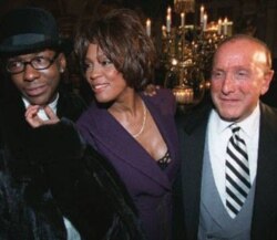 Whitney Houston, husband Bobby Brown, left, and Clive Davis, president and founder of Arista Records, in New York City in 1998