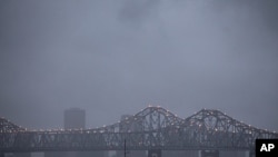 Heavy rain clouds from approaching Tropical Storm Lee form over the skyline of New Orleans and the Crescent City Connection bridges at dusk, September 2, 2011.