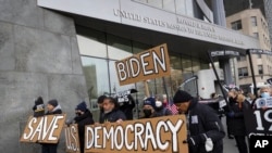 FILE - Activists from Fair Elections for New York, Black Voters Matter and Workers Circle march for voting rights outside the U.S. Mission to the United Nations as President Joe Biden opens a global democracy summit, Dec. 9, 2021, in New York.