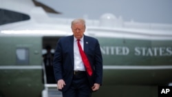 FILE - President Donald Trump walks from Marine One to board Air Force One, at Andrews Air Force Base, Maryland, May 14, 2020.