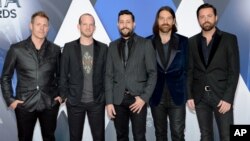 FILE - Members of Old Dominion, from left, Trevor Rosen, Whit Sellers, Matthew Ramsey, Geoff Sprung and Brad Tursi arrive at the 49th annual CMA Awards at in Nashville, Tennessee, Nov. 4, 2015.