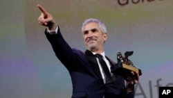 Director Alfonso Cuaron holds the Golden Lion Best Film award for 'Roma' at the closing ceremony of the 75th edition of the Venice Film Festival in Venice, Italy, Sept. 8, 2018.