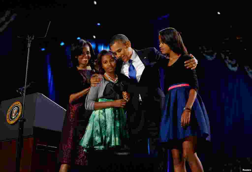 November 6: U.S. President Barack Obama celebrates with first lady Michelle Obama and their daughters Malia (R) and Sasha at an election night victory rally in Chicago, Illinois. 