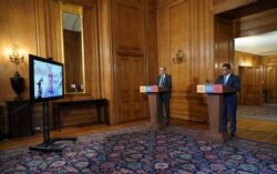 A press coronavirus briefing at Downing Street with Business Secretary Alok Sharma, right, and Medical Director Professor Stephen Powis, during a Digital Press Conference in London, Saturday March 28, 2020.