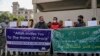 Activists from JKNPF hold banners and placards during a demonstration in Srinagar on Oct. 19, 2021 against the incident in which two laborers from India's Bihar state were reportedly killed by gunmen in Indian-administered Kashmir.