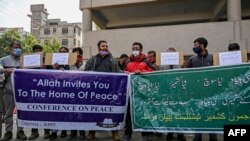 Activists from JKNPF hold banners and placards during a demonstration in Srinagar on Oct. 19, 2021 against the incident in which two laborers from India's Bihar state were reportedly killed by gunmen in Indian-administered Kashmir.