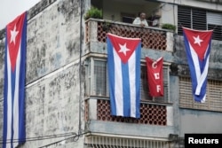 Cuban flags cover the windows of the house of actor, playwright and leader of the Facebook group called Archipelago, Yunior Garcia, in Havana, Cuba, November 15, 2021.