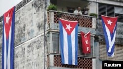 Cuban flags cover the windows of the house of actor, playwright and leader of the Facebook group called Archipelago, Yunior Garcia, in Havana, Cuba, November 15, 2021. 
