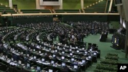 FILE - This photo taken Feb. 19, 2017, shows an open session of the Iranian parliament. The parliament backed the removal from office of Masoud Karbasian, minister of finance and economic affairs, by 137 votes to 121 against.
