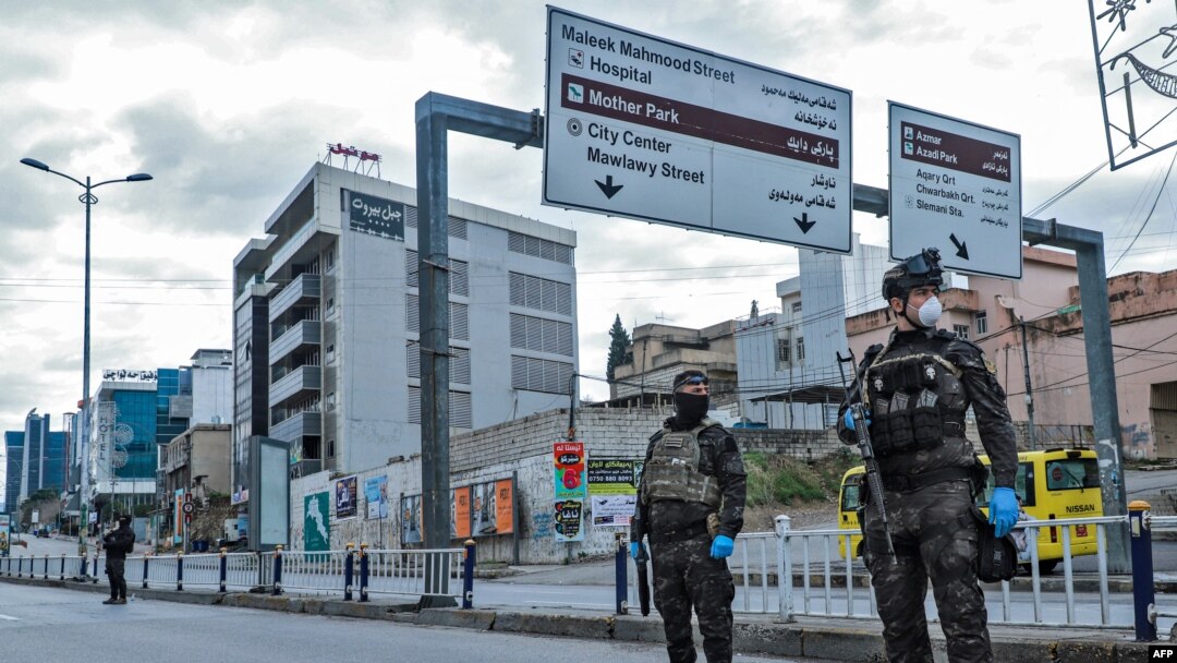 Security forces stand at a checkpoint in the city of Sulaimaniyah