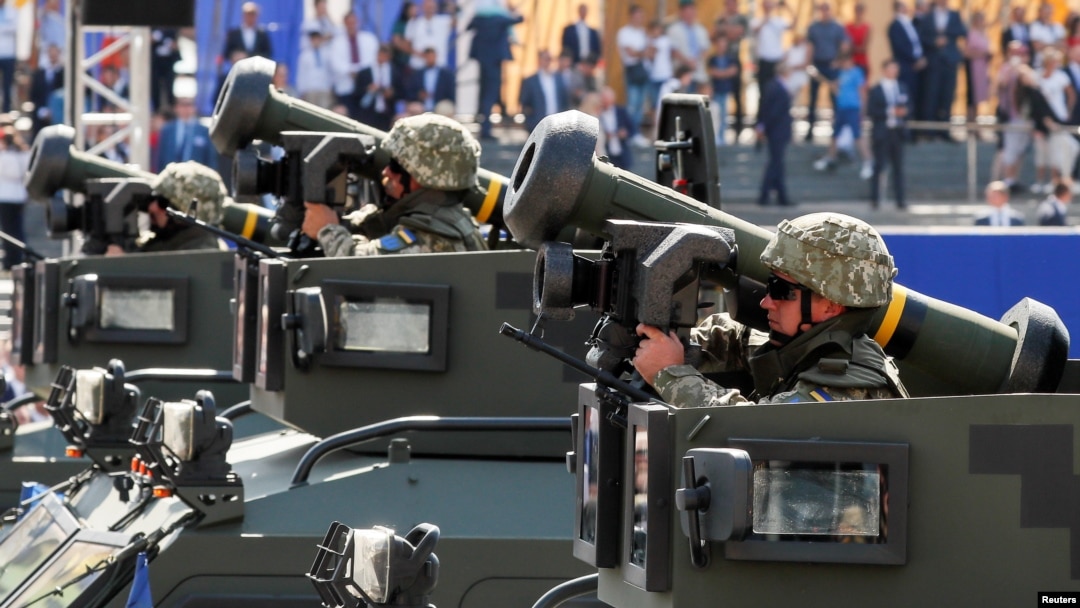 FILE - Ukrainian soldiers ride with Javelin anti-tank missiles during a military parade marking Ukraine's Independence Day, in Kyiv, Aug. 24, 2018. 
