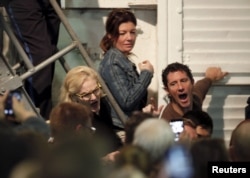 Trump supporters yell at passing protesters (unseen), who are against Trump's policies, during a rally by U.S. Republican presidential candidate Donald Trump aboard the USS Yorktown Memorial in Mount Pleasant, S.C., Dec. 7, 2015.