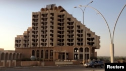 FILE - A banner of the Islamic State of Iraq and the Levant (ISIL) is seen on the top of Hotel Nineveh in the city of Mosul, June 27, 2014.