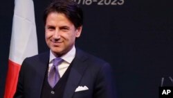FILE - Giuseppe Conte smiles during a meeting in Rome as Italy edged toward its first populist government, March 1, 2018. 