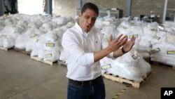 Venezuelan exiled lawmaker Jose Manuel Olivares talks to the media during a tour to see stored humanitarian aid at a warehouse next to the Tienditas International Bridge on the outskirts of Cucuta, Colombia, on the border with Venezuela, Feb. 19, 2019. 