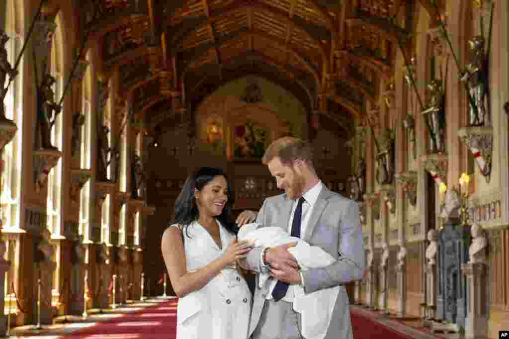 Britain's Prince Harry and Meghan, Duchess of Sussex, during a photocall with their newborn son, Archie, in St. George's Hall at Windsor Castle, Windsor, England.