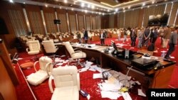 Men inspect the General National Congress building, a day after protesters stormed into the building in Tripoli. (March 3, 2014.) 