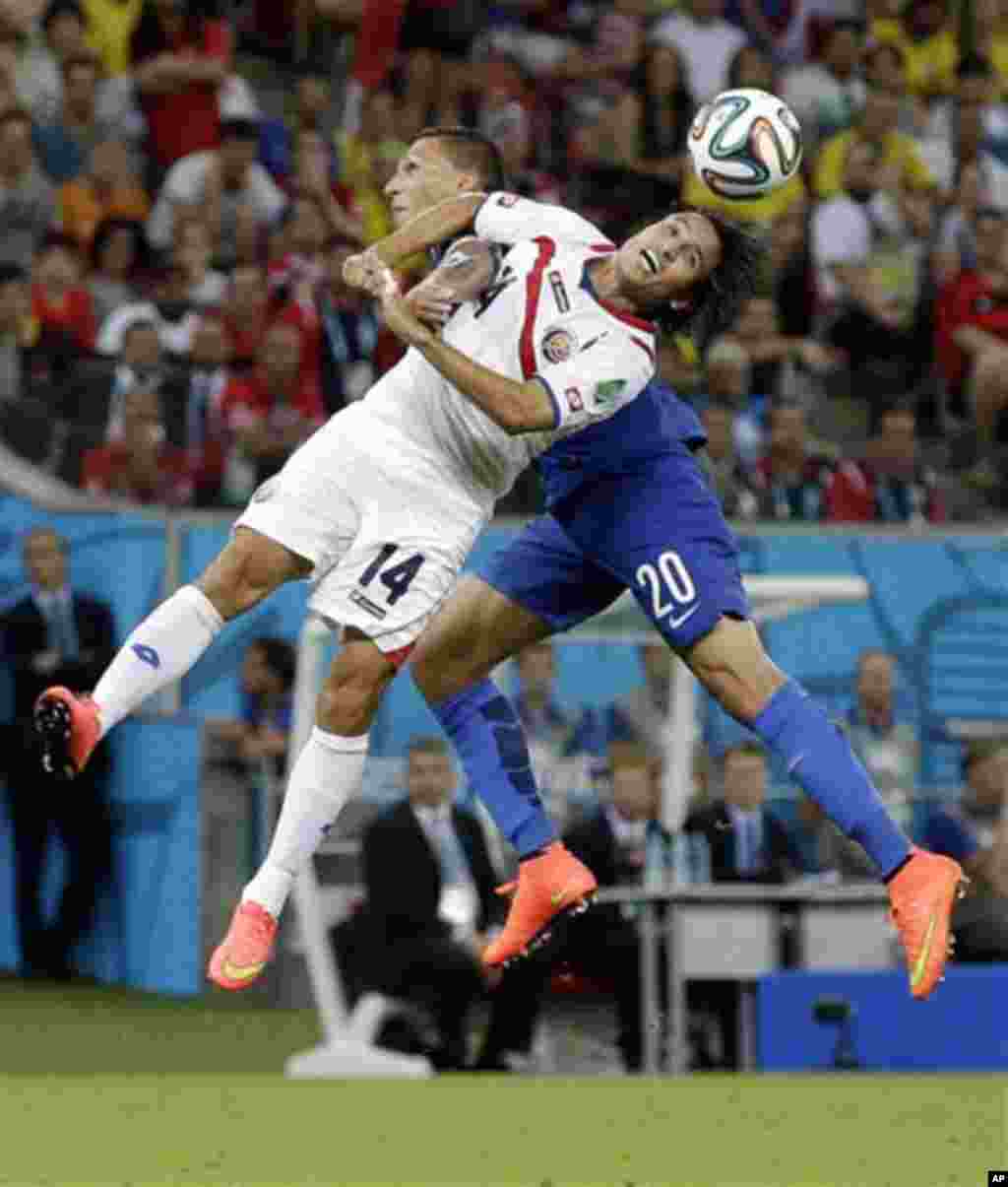 Costa Rica's Randall Brenes, and Greece's Jose Holebas battle for the ball during the World Cup round of 16 soccer match between Costa Rica and Greece at the Arena Pernambuco in Recife, Brazil, Sunday, June 29, 2014. (AP Photo/Andrew Medichini)