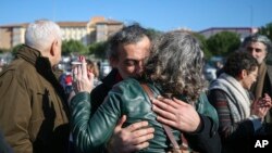 Family members, friends celebrate after a court acquitted 9 leading Turkish civil society activists, including Osman Kavala, an entrepreneur known for philanthropy who has been jailed for more than two years, in Silivri, outside Istanbul, Feb. 18, 2020. 