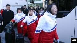 FILE - North Korean female hockey players arrive at the Inter-Korean Transit Office in Paju, South Korea, Jan. 25, 2018. 