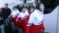 FILE - North Korean female hockey players arrive at the Inter-Korean Transit Office in Paju, South Korea, Jan. 25, 2018. 
