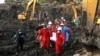 Red Cross personnel carry the body of a victim at the site of a collapsed landfill in Kampala, Uganda, Aug. 11, 2024. 