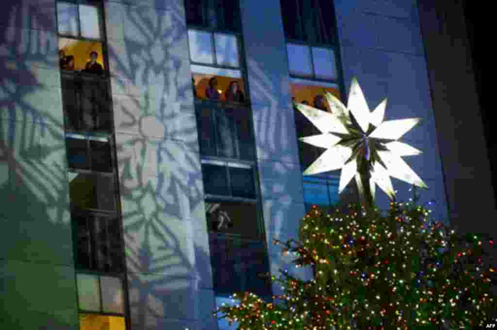 The 74-foot-tall Rockefeller Center Christmas tree is lit using 30,000 energy efficient LED lights during the 79th annual lighting ceremony, in New York, Wednesday, Nov. 30, 2011. (AP Photo/Charles Sykes)