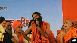 Renowned yoga guru Baba Ramdev, center, speaks during his hunger strike against corruption in New Delhi, India, June 4, 2011