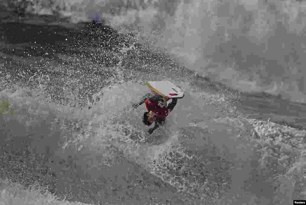 A bodyboarder rides a wave during Sumol Nazare Special Edition in Nazare, Portugal, Mar.19, 2014.