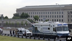 Law enforcement work near the Pentagon after a suspicious vehicle forced multiple road closures, June 17, 2011 in Arlington, Va.