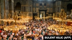 Worshippers pray in Hagia Sophia, in Istanbul, on July 26, 2020, during the first Muslim prayers since the controversial reconversion of the iconic Istanbul cathedral into a mosque.