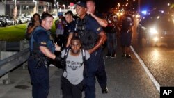 FILE - In this July 9, 2016 photo, police officers arrest activist DeRay McKesson during a protest along Airline Highway, a major road that passes in front of the Baton Rouge Police Department headquarters in Baton Rouge, La., after the fatal shooting of 